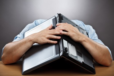 man with laptop over his head